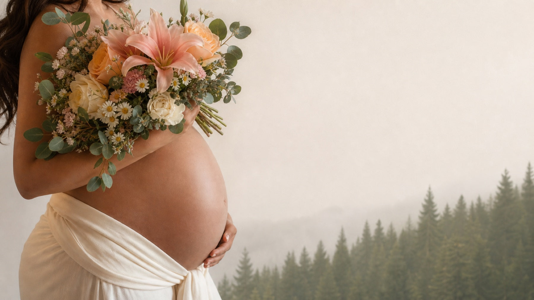 Pregnant woman holding a bouquet with a misty evergreen forest