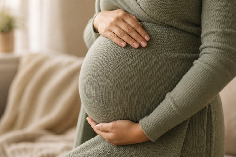 Pregnant person holding their belly